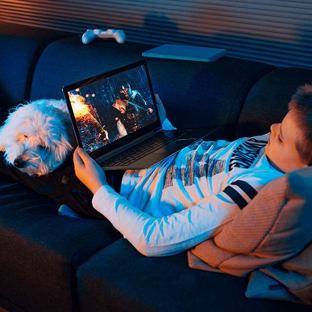 boy with dog watching tablet