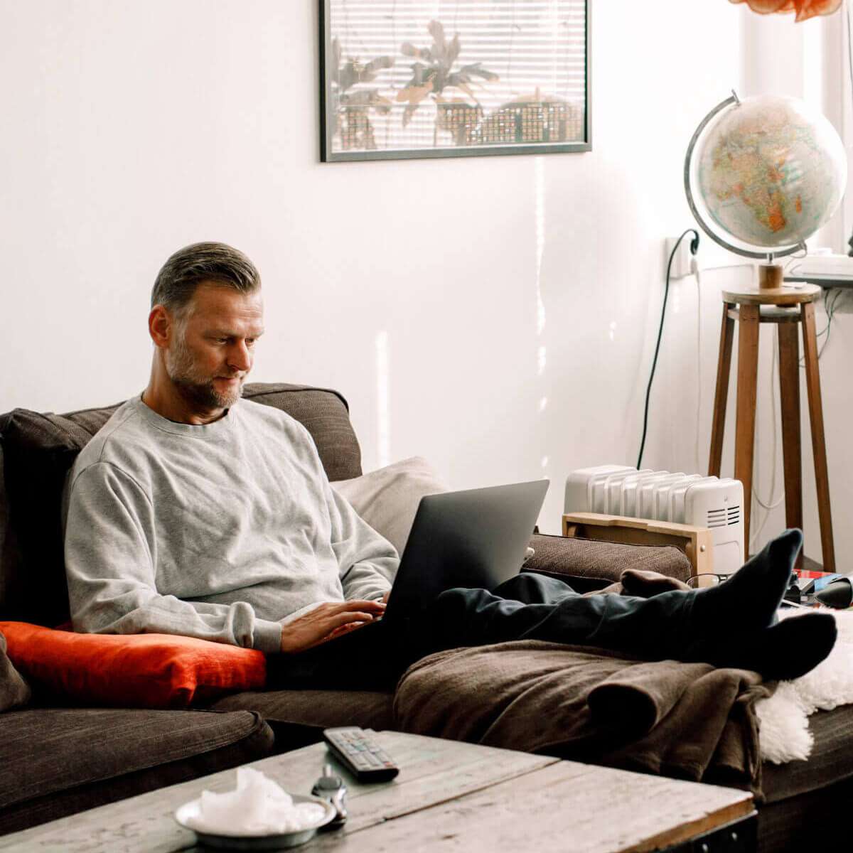 man on couch with laptop