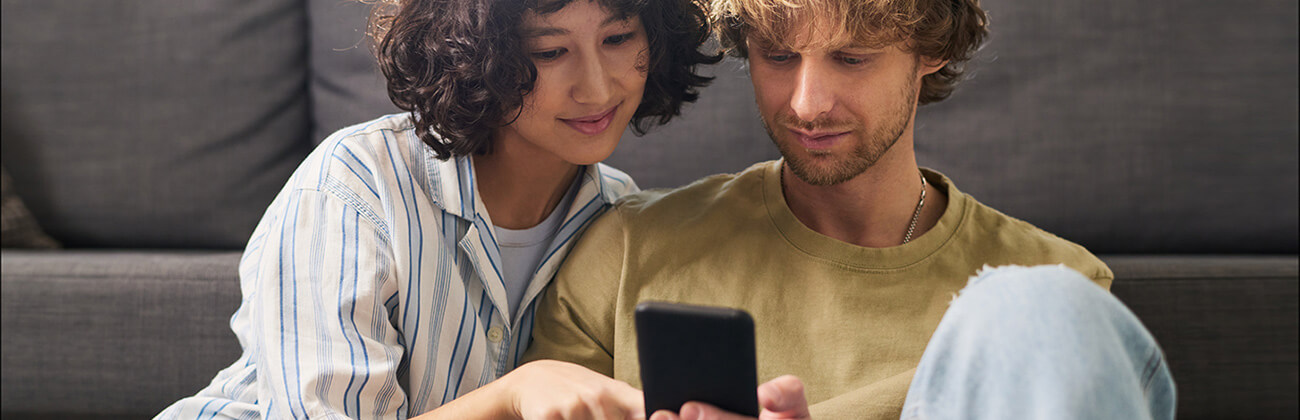 Couple looks at mobile data usage on phone