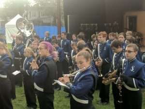 band warming up their instruments