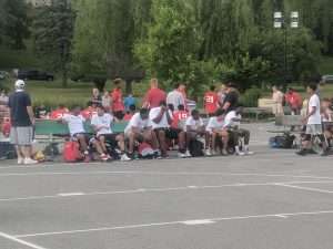 young men playing basketball outside