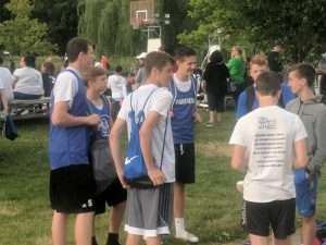 young men playing basketball outside