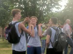 young men playing basketball outside