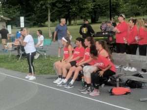 young women playing basketball outside