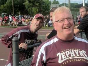 two coaches posing for photo