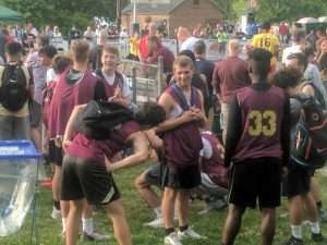young men's basketball team hanging out outside