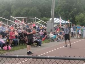 young mens basketball game outside