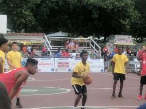 young mens basketball game outside