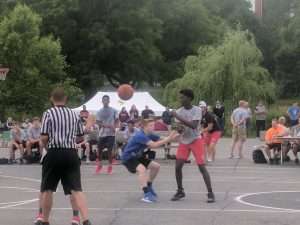 young mens basketball game outside