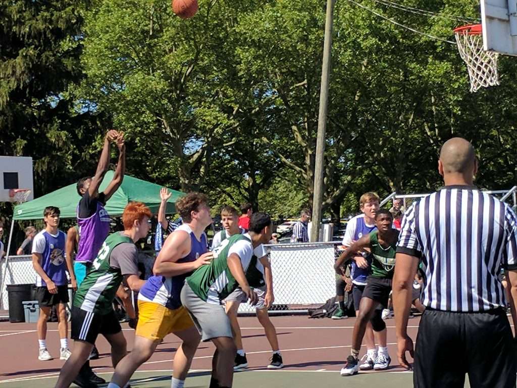 action image of a high school men's outdoor basketball game shooting a free throw