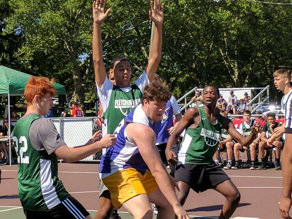 action image of a high school men's outdoor basketball game