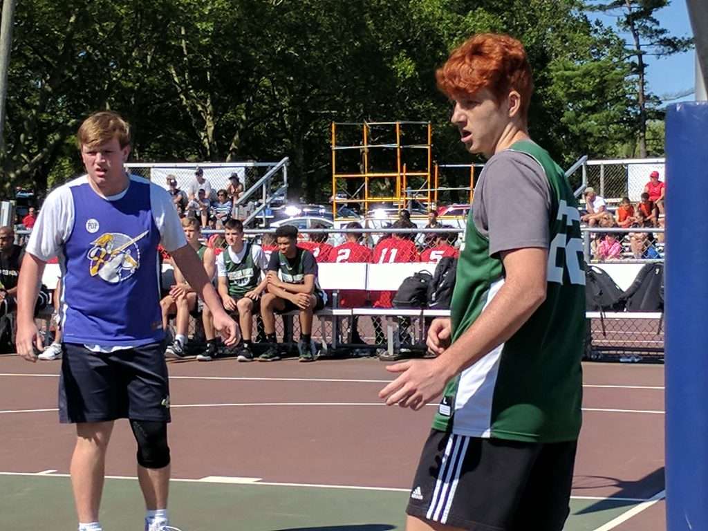 action image of a high school men's outdoor basketball game