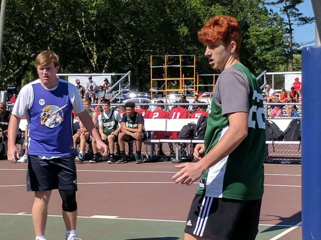 action image of a high school men's outdoor basketball game