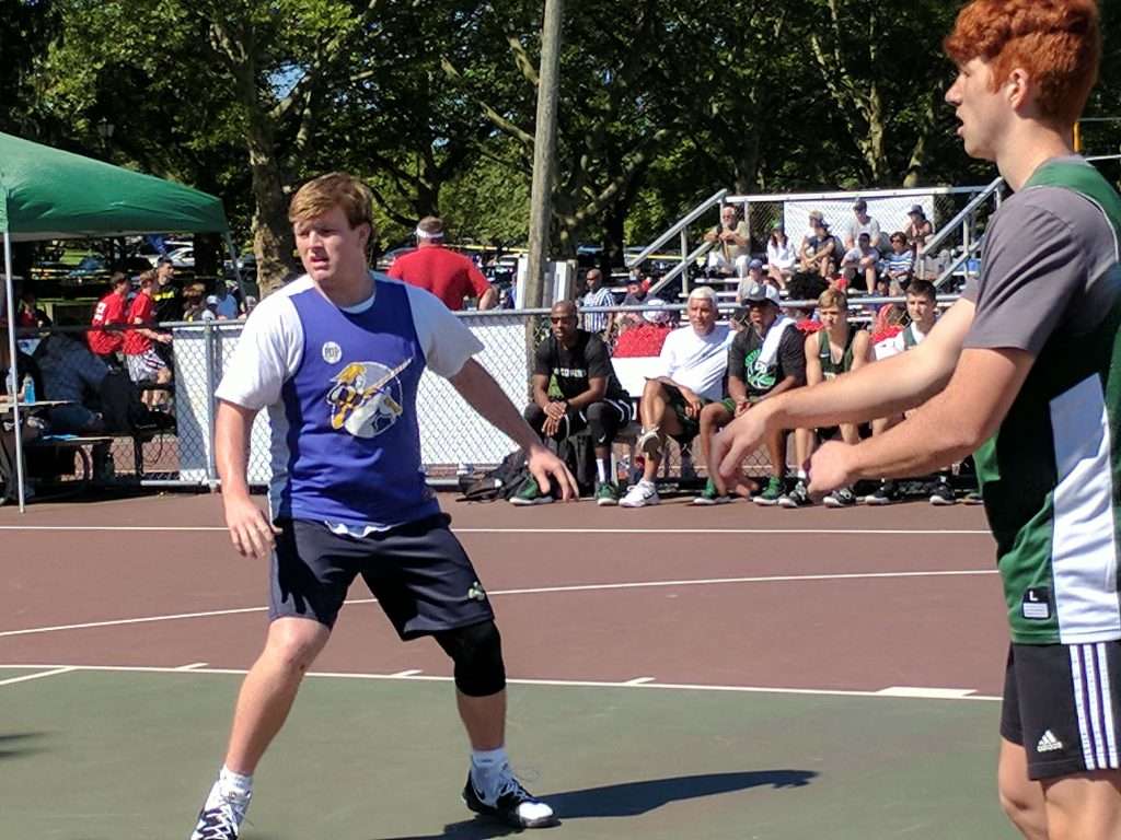 action image of a high school men's outdoor basketball game