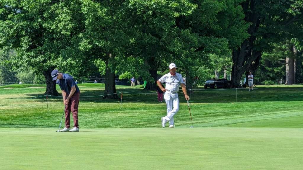 man hitting golf ball on golf course