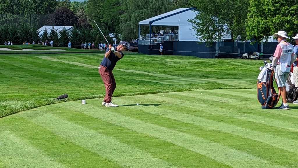 man hitting golf ball on golf course