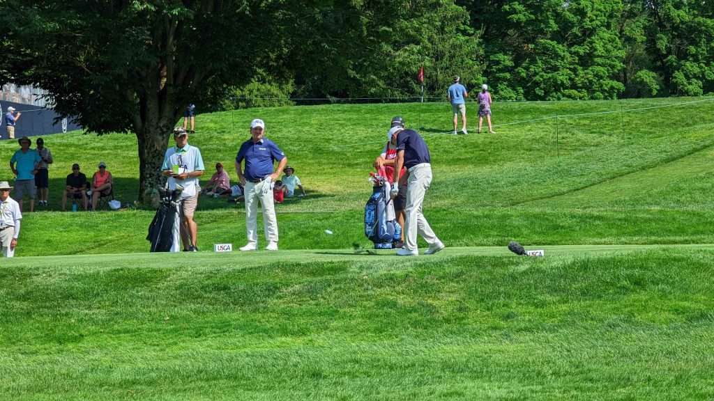 man hitting golf ball on golf course