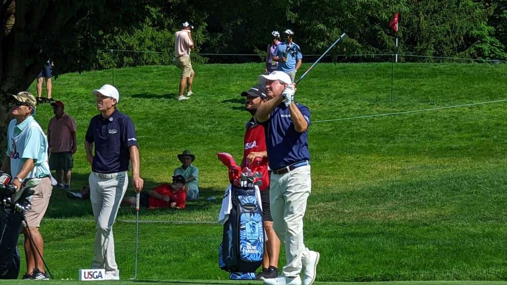 man hitting golf ball on golf course