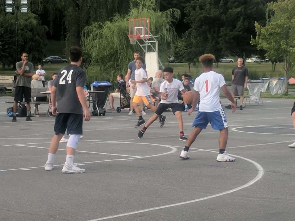 action image of a high school outdoor basketball game