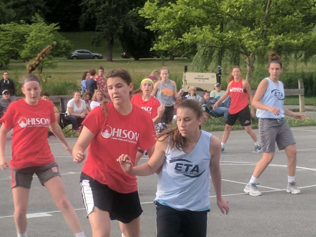 action image of a high school womens outdoor basketball game