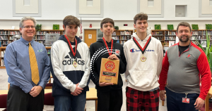 3 High school boys accepting EPSEI award with two coaches