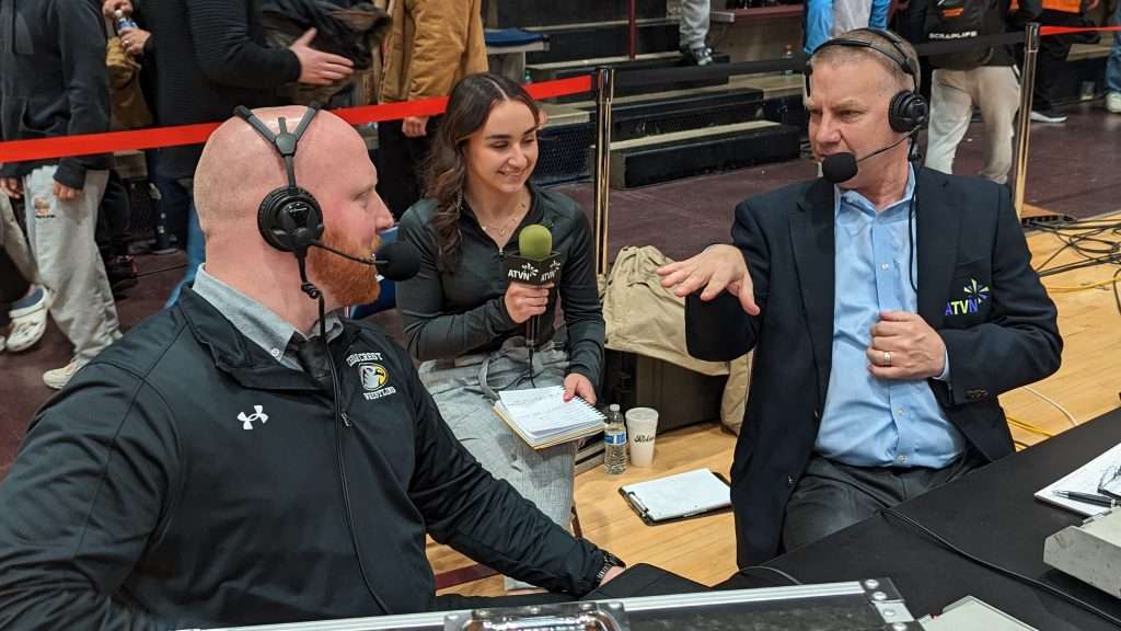 ATVN sports announcer speaking with student newscaster and co host