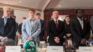 high school football students standing to accept awards at 2023 football scholar night