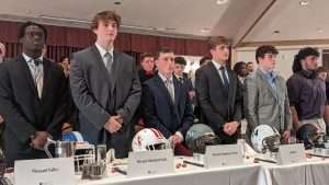 high school football students standing to accept awards at 2023 football scholar night