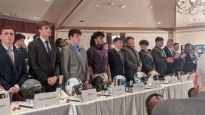 high school football students standing to accept awards at 2023 football scholar night