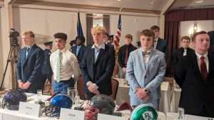 high school football students standing to accept awards at 2023 football scholar night