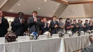 high school football students standing to accept awards at 2023 football scholar night