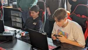 two high school boys competing in video games on their computers