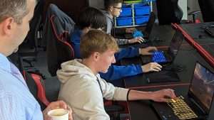 three boys competing on their computers