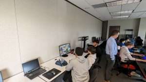 6 boys competing a their computers at a racing game