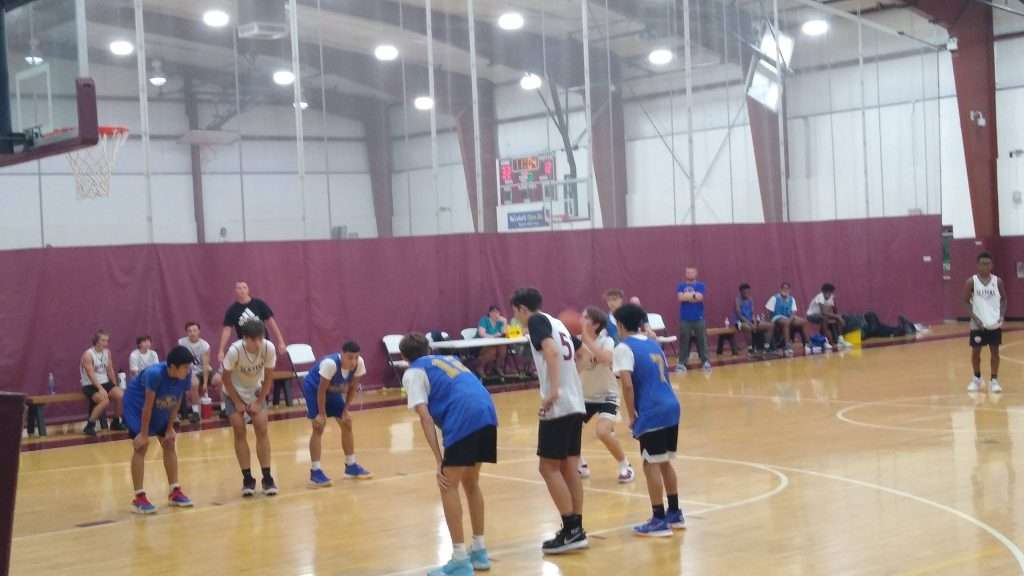 High school basketball game action shot of players shooting a free throw