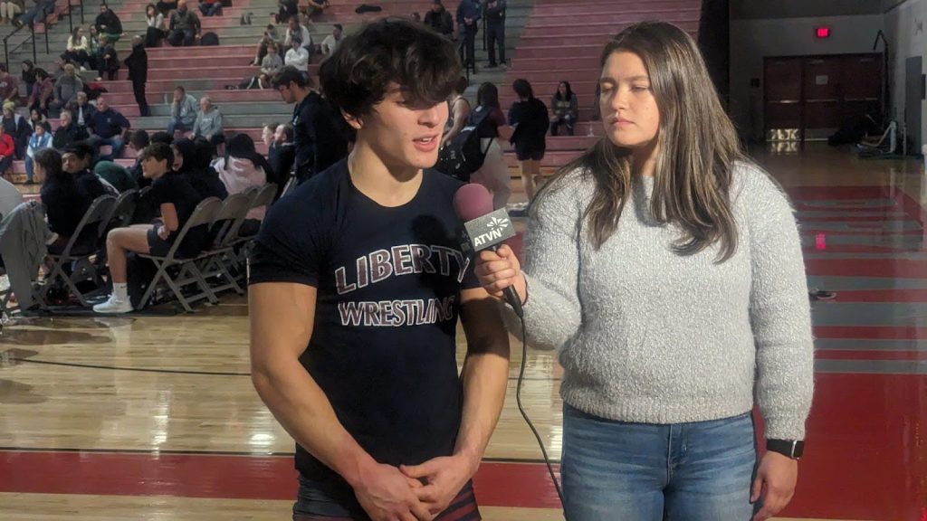 ATVN broadcaster interviewing a high school men's wrestler