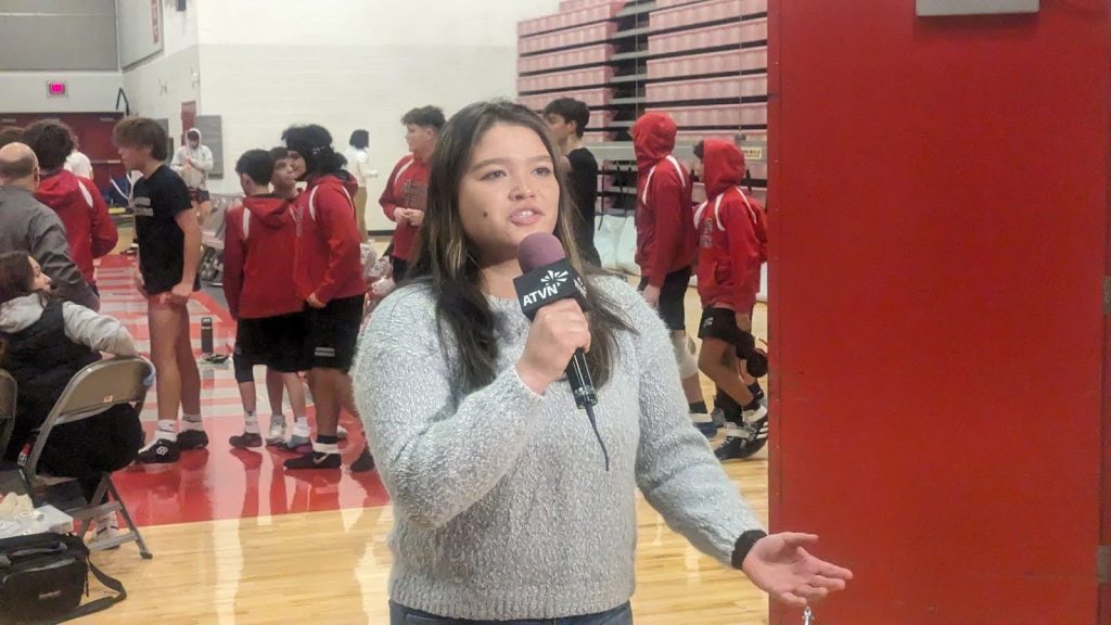ATVN broadcaster reporting at a high school wrestling match