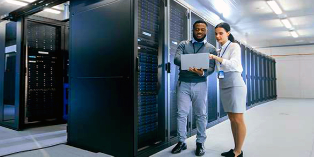 CIO challenges - two co-workers look over reports in a high tech data center
