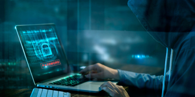 hooded figure launches a ransomware attack