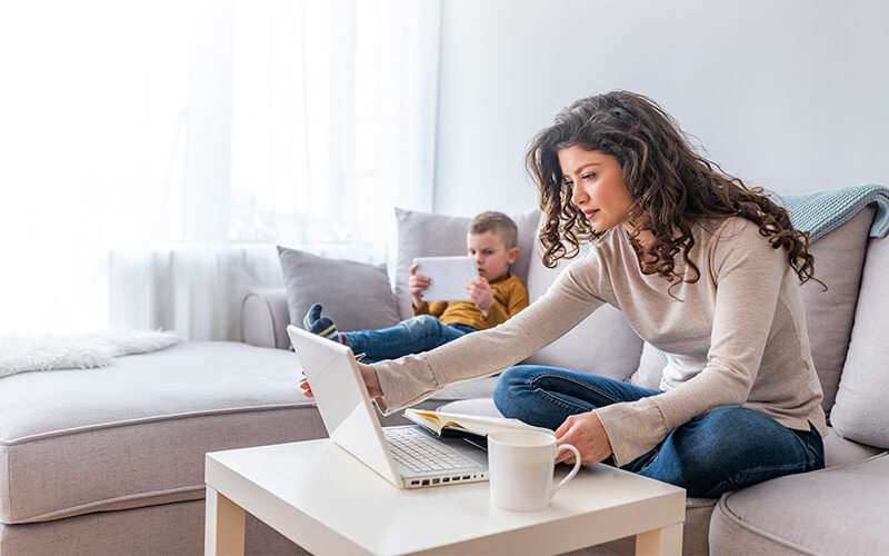 Family on couch with devices