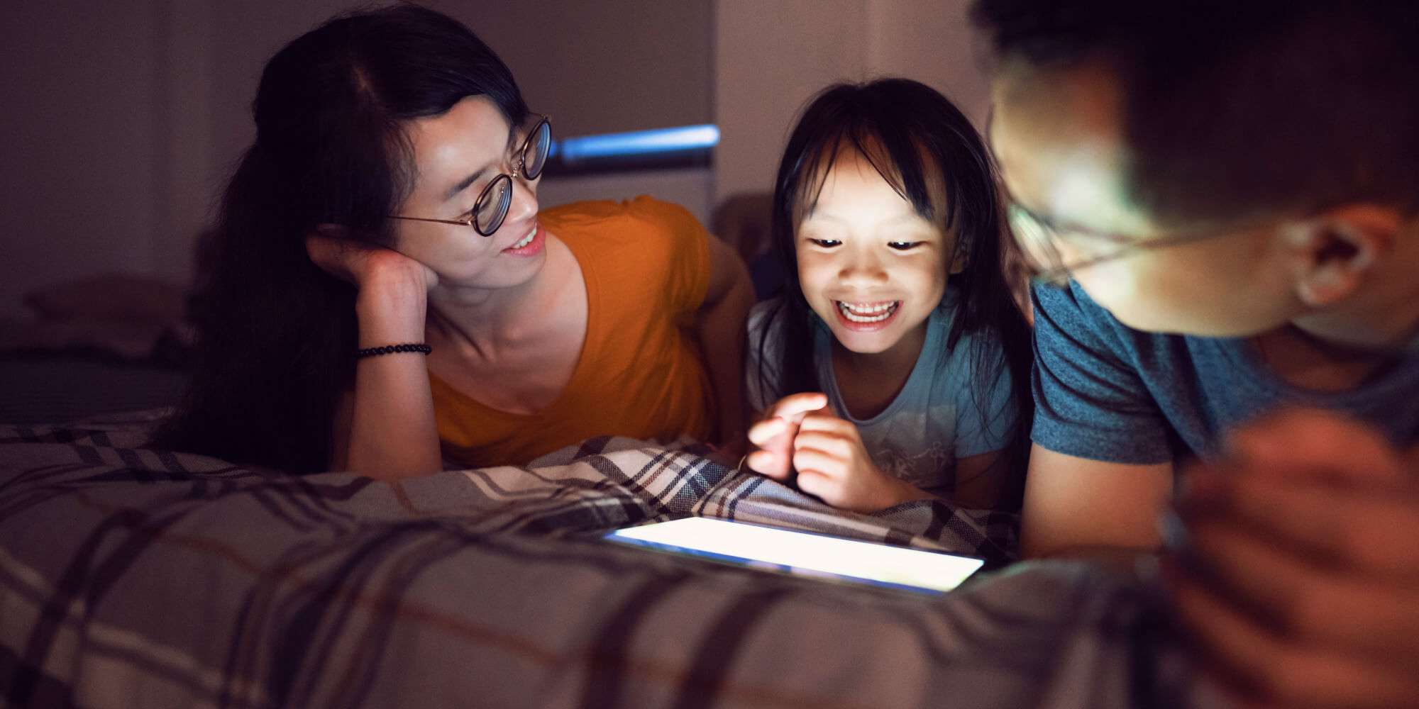 Taiwanese ethnicity parents watching funny cartoons