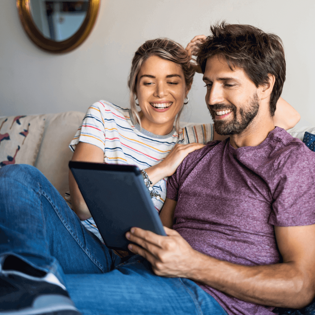 Couple on couch streaming on tablet