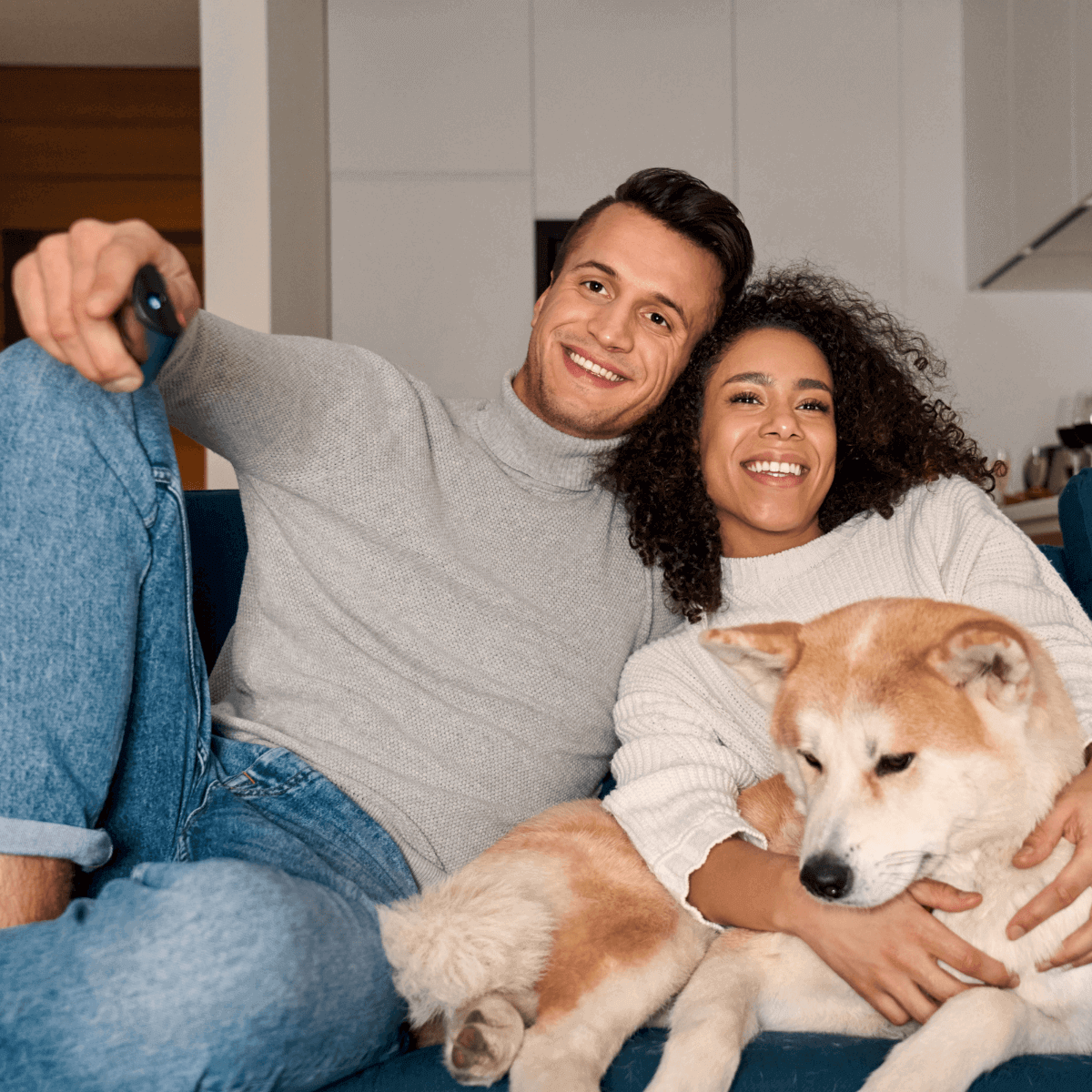 Couple with dog watching TV