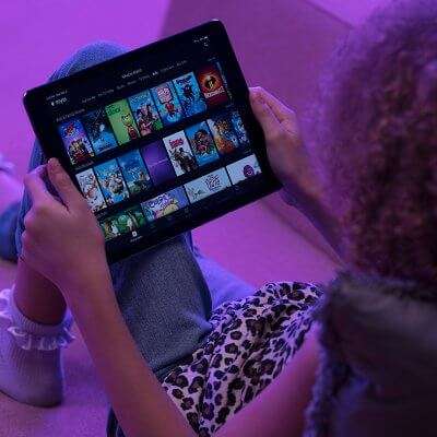 young person choosing movie on tablet