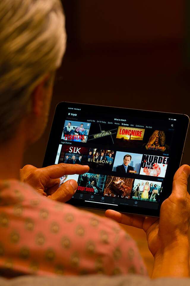 woman choosing movie on tablet