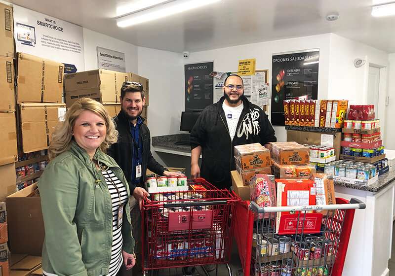 three people helping out at a food bank