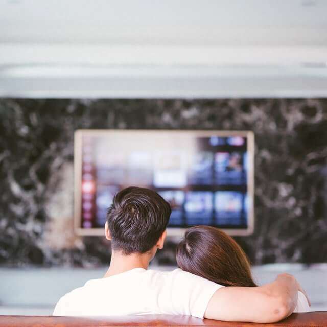 couple on couch watching tv
