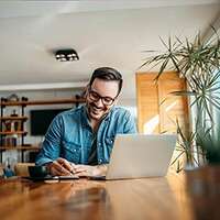 Man in home working on laptop