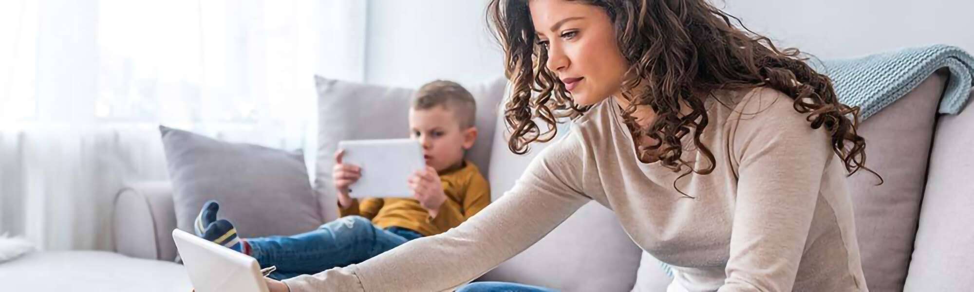 Family on couch with devices