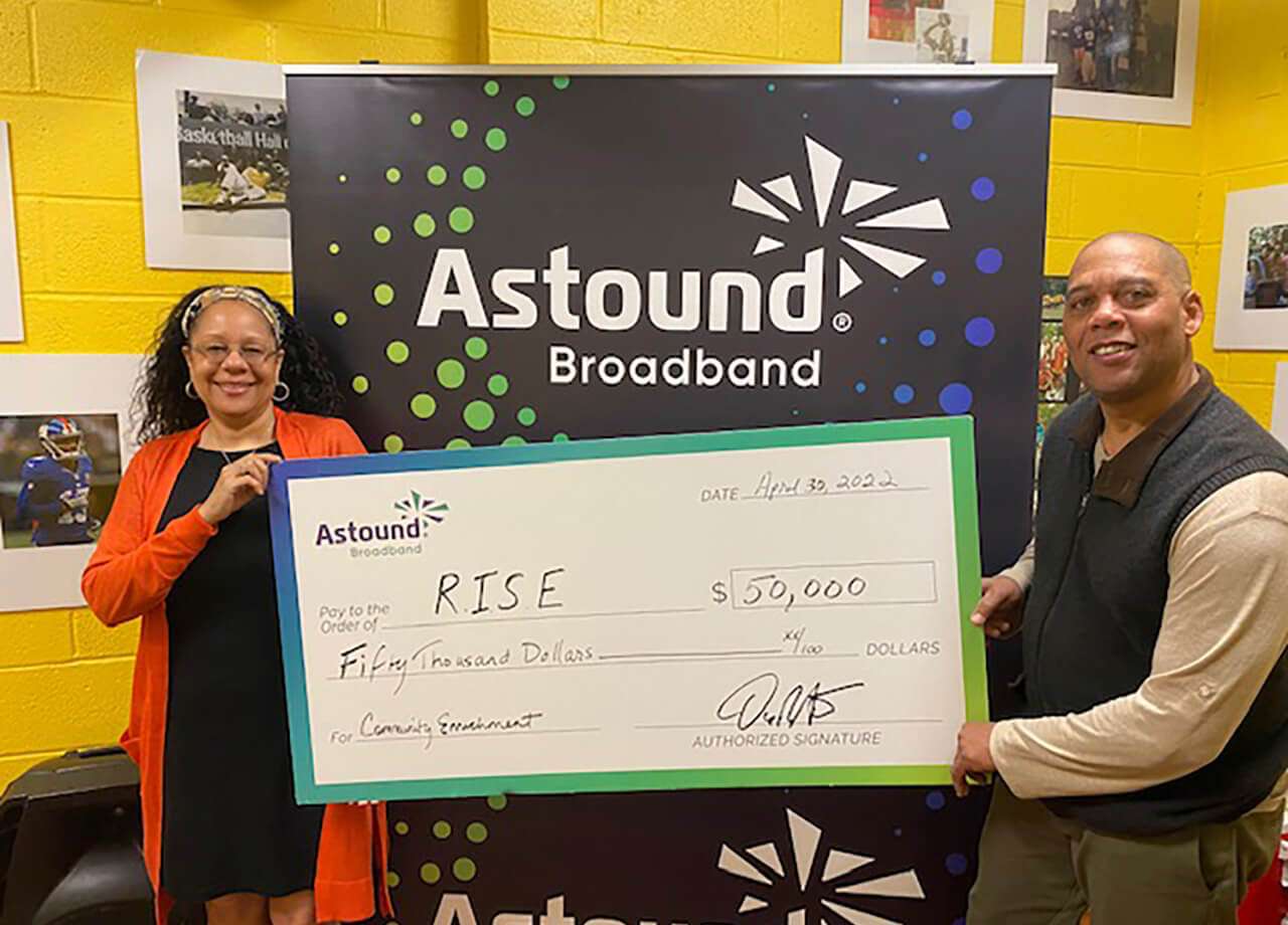 astound handing a giant check to RISE